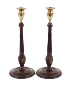 Pair of George III mahogany and brass candlesticks.