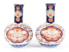 A pair of 19th century Japanese Imari pattern bottle shaped vases.