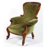 A Victorian mahogany framed upholstered armchair.