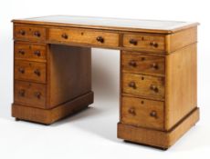 A Victorian oak pedestal desk with tooled green leather top.