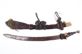 A 19th century Gambian Mandinka sword and tooled leather sheath with leather handle.
