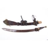 A 19th century Gambian Mandinka sword and tooled leather sheath with leather handle.