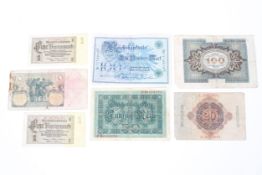 An assortment of German third Reich and other bank notes and stamps.