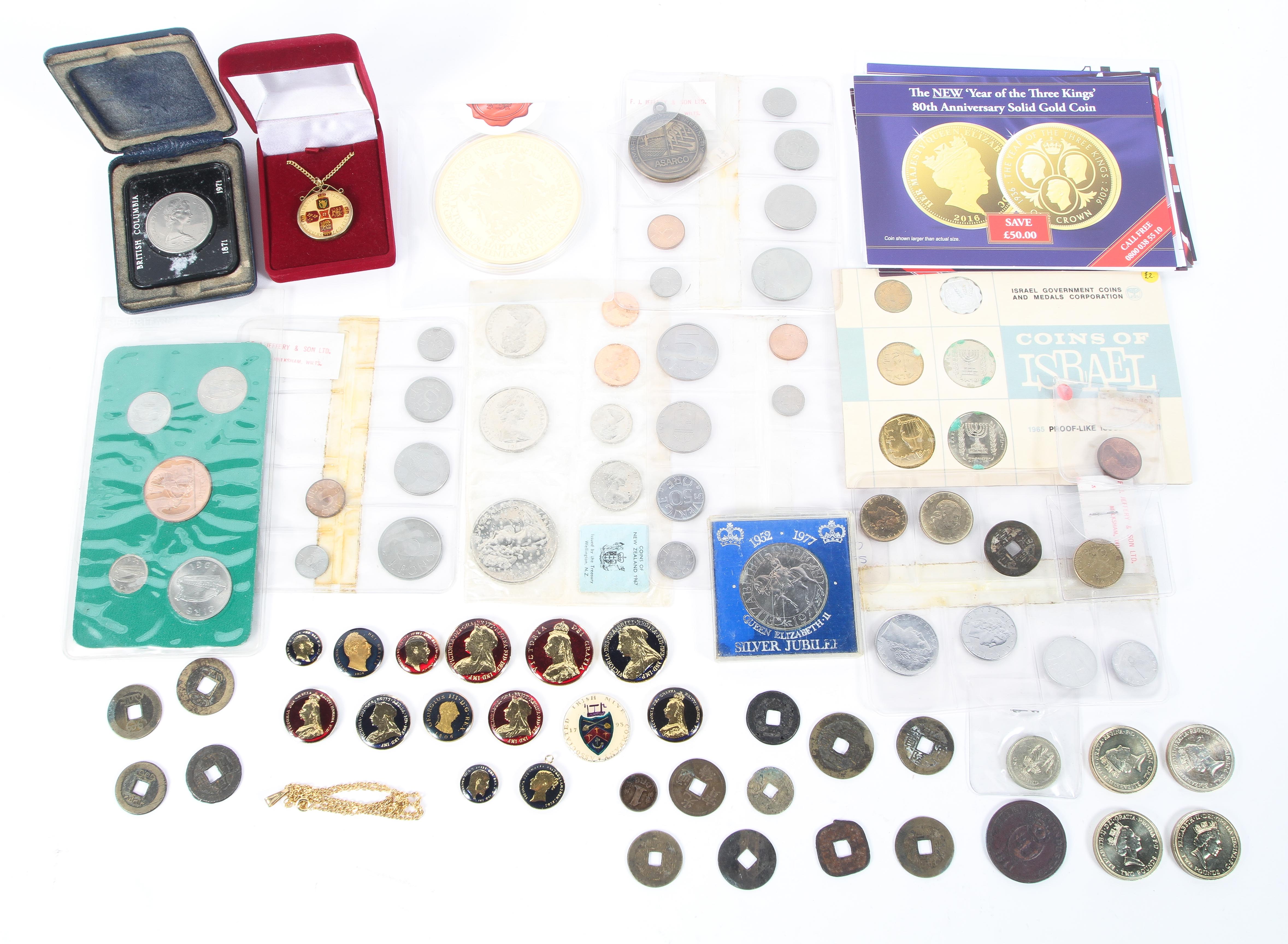 A collection of assorted coins. Including 15 enamelled coins and other assorted coins.