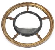 A Regency style circular giltwood mirror.