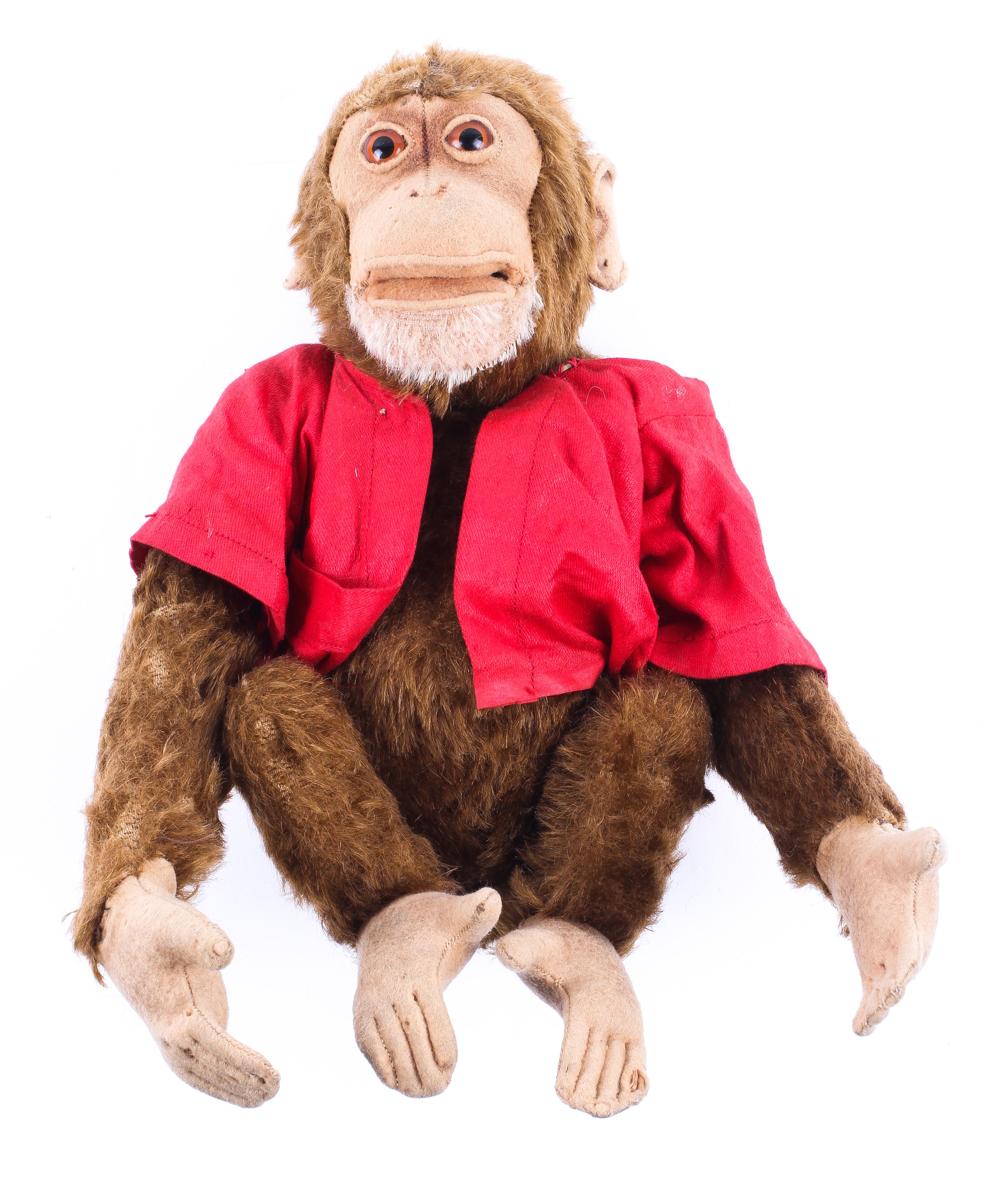 A Steiff monkey wearing a red jacket, early/mid-20th century.