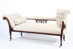 An Edwardian mahogany framed upholstered chaise longue.