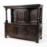 A carved oak court cupboard in the 17th century style.