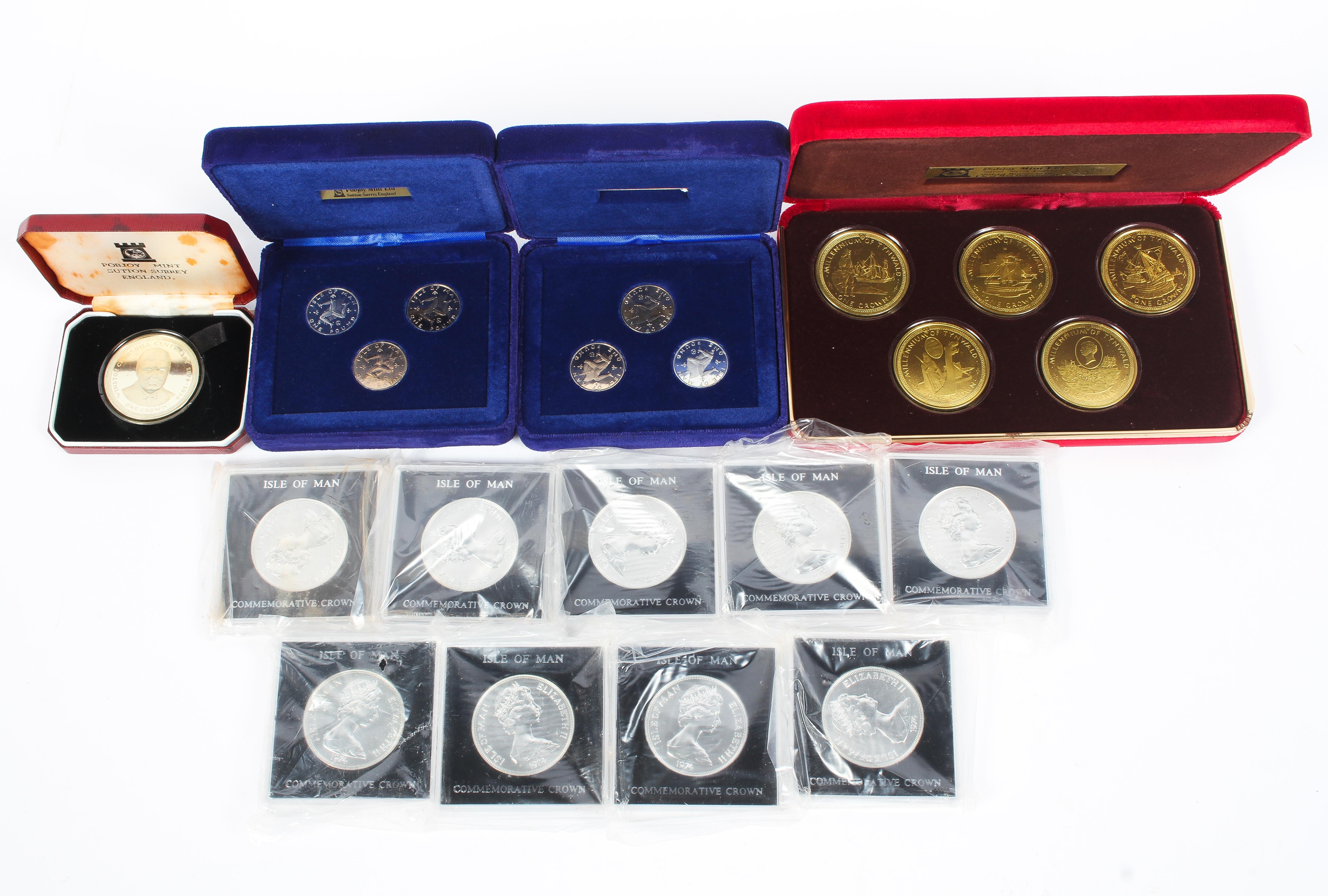 A collection of Isle of Man commemorative silver and white metal coin sets.