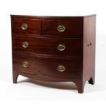 An early 19th century mahogany bow fronted chest of drawers.