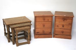 A pair of contemporary pine bedside cabinets and nest of three tables.