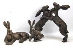 Three resin sculptures featuring hares.