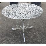 A white painted metal garden table with pierced decoration.