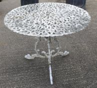 A white painted metal garden table with pierced decoration.
