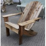 A large wood garden chair with reclined back.
