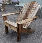 A large wood garden chair with reclined back.
