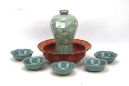 A Celedon ceramic vase and five dishes.