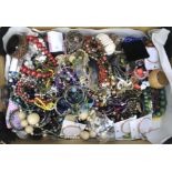 Assorted costume jewellery including bangles, necklaces, and more.