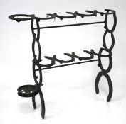 A stick stand constructed of iron horse shoes.