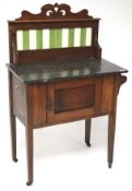 A Victorian mahogany wash stand, with marble top and a carved and tiled back,