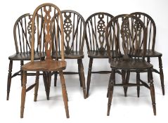 A set of five wheel back dining chairs and a Chippendale chair.