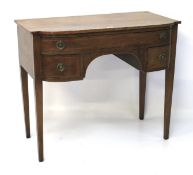 A veneered bow fronted keyhole desk.