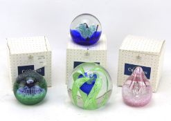 Four Caithness paperweights.