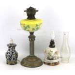Two ceramic table lamps and an oil lamp.