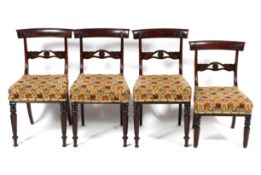 Four mid-19th century mahogany dining chairs.