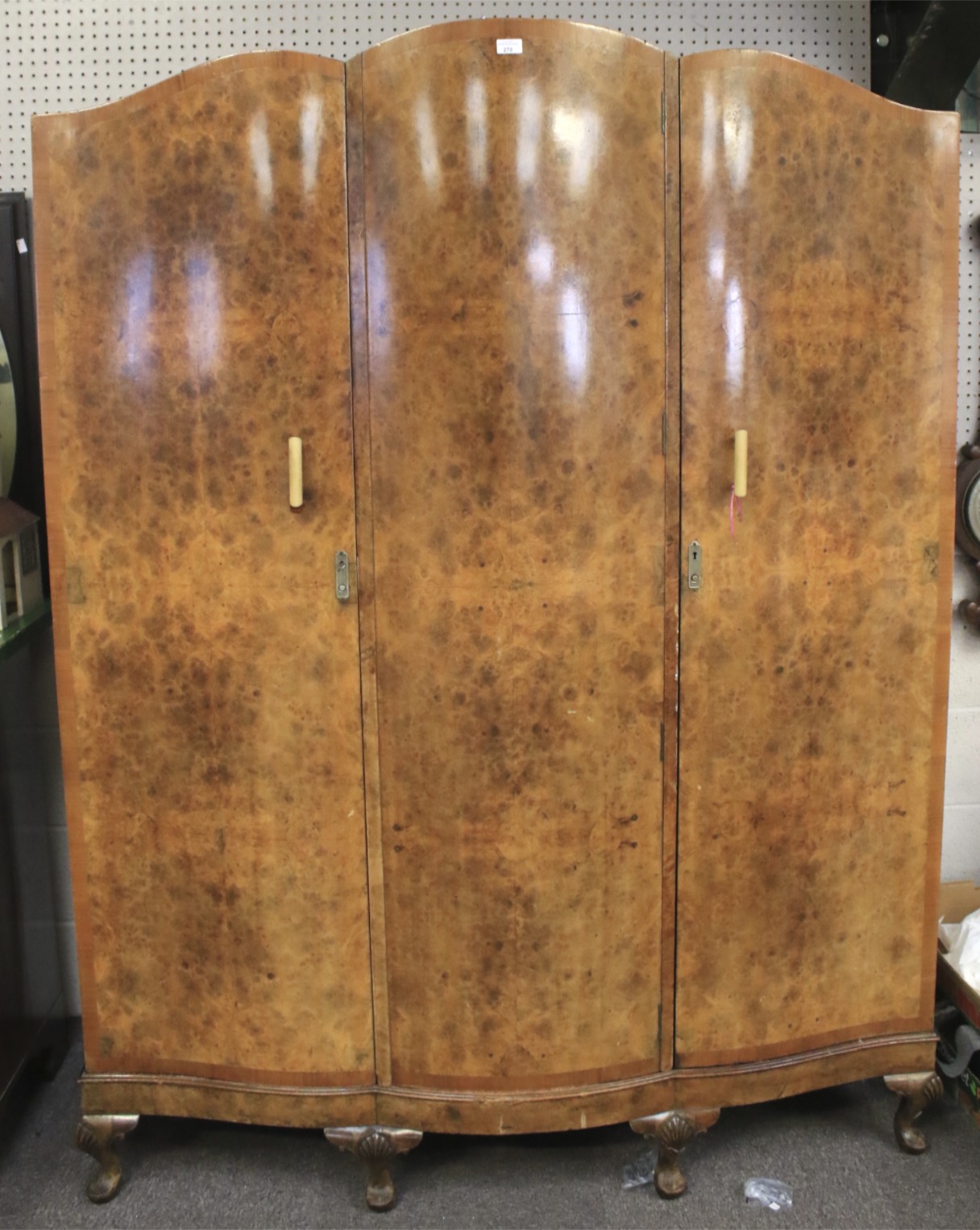 An Art Deco burr walnut triple-door wardrobe.