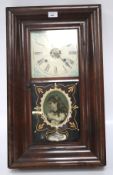 An early 20th century mahogany veneer wall clock by Waterbury clock Co.