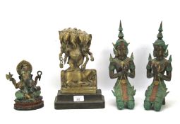 Four Asian figures.