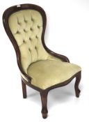 A mahogany framed button back nursing chair.