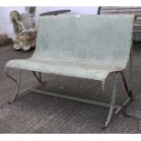 A green painted metal industrial outdoor bench, possibly from the railway.