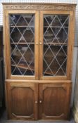 An oak glazed cabinet.