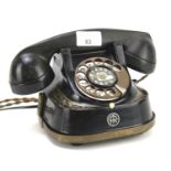 A vintage Belgium telephone. In black with gilt decoration with the M.F.C.