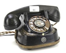 A vintage Belgium telephone. In black with gilt decoration with the M.F.C.