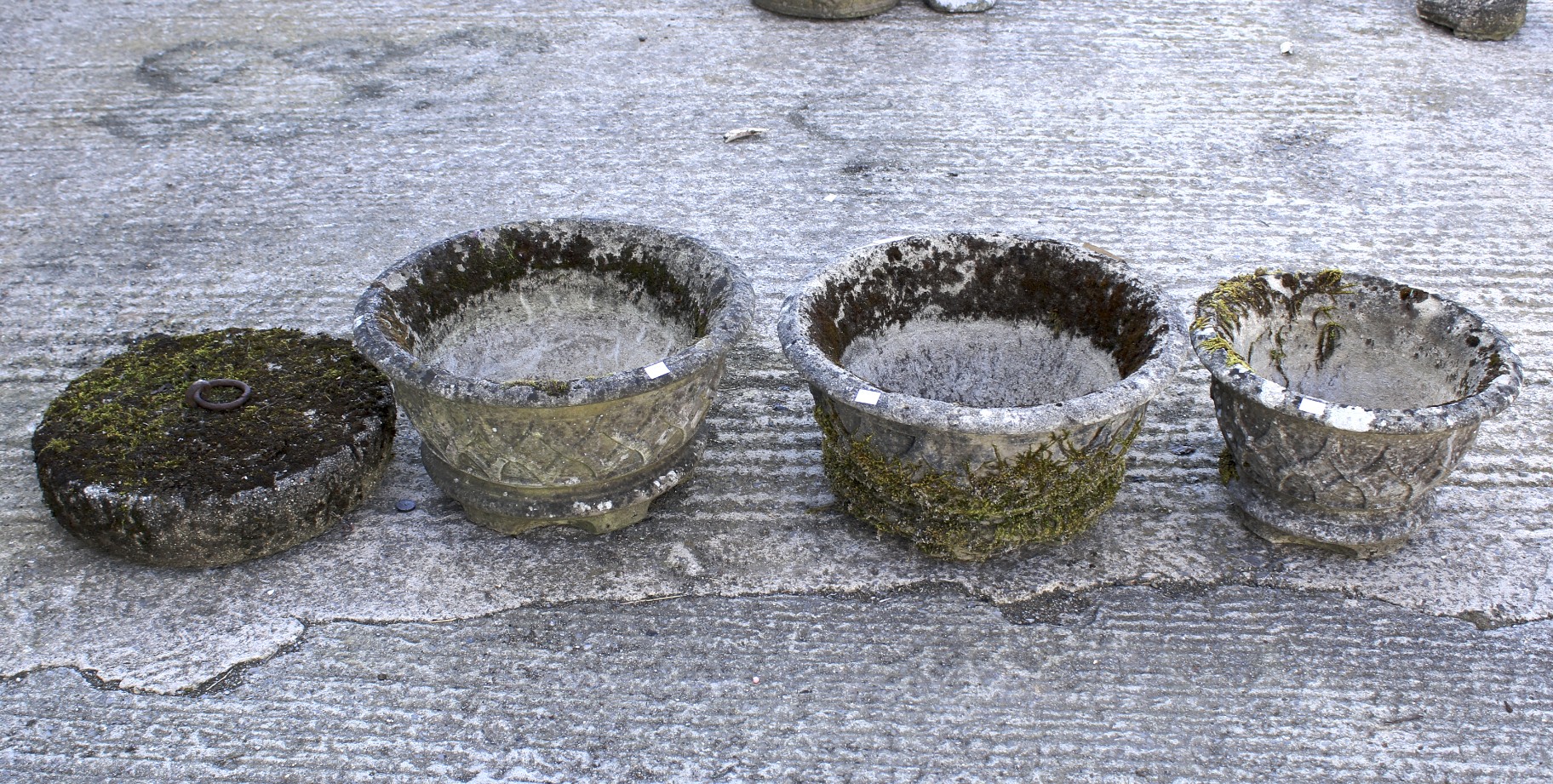 Three stone pots and horse tether with ring.