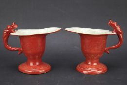 A pair of Chinese 20th century red glazed libation cups.