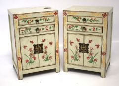 A pair of painted bedside cabinets.