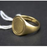 A 9ct gold gentleman's signet ring. With engine turned band decoration, weight 5.