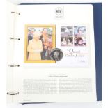 A folder containing The Queen's Golden Jubilee Coin First Day covers