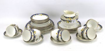 A Royal Albert part tea service in the 'Primrose' pattern, including cups and saucers, plates,