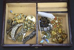 A jewellery box containing an assortment of costume jewellery.