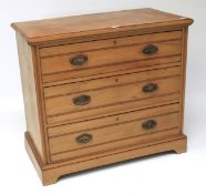 A 20th century satinwood chest of three drawers.