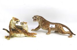 Two 20th century ceramic figures of leopards.