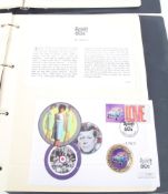 A folder containing the Spirit of the 60s Coin Cover set and a Beatles stamp cover set.