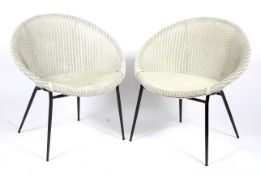 Two Lloyd Loom wicker chairs designed by Geoffrey Lusty.