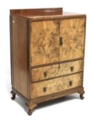 A burr walnut veneered cabinet and matching dressing table.