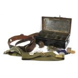An officer's brown leather belt and a metal box containing an assortment of collectables.